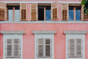 a big house with pink wall and many windows